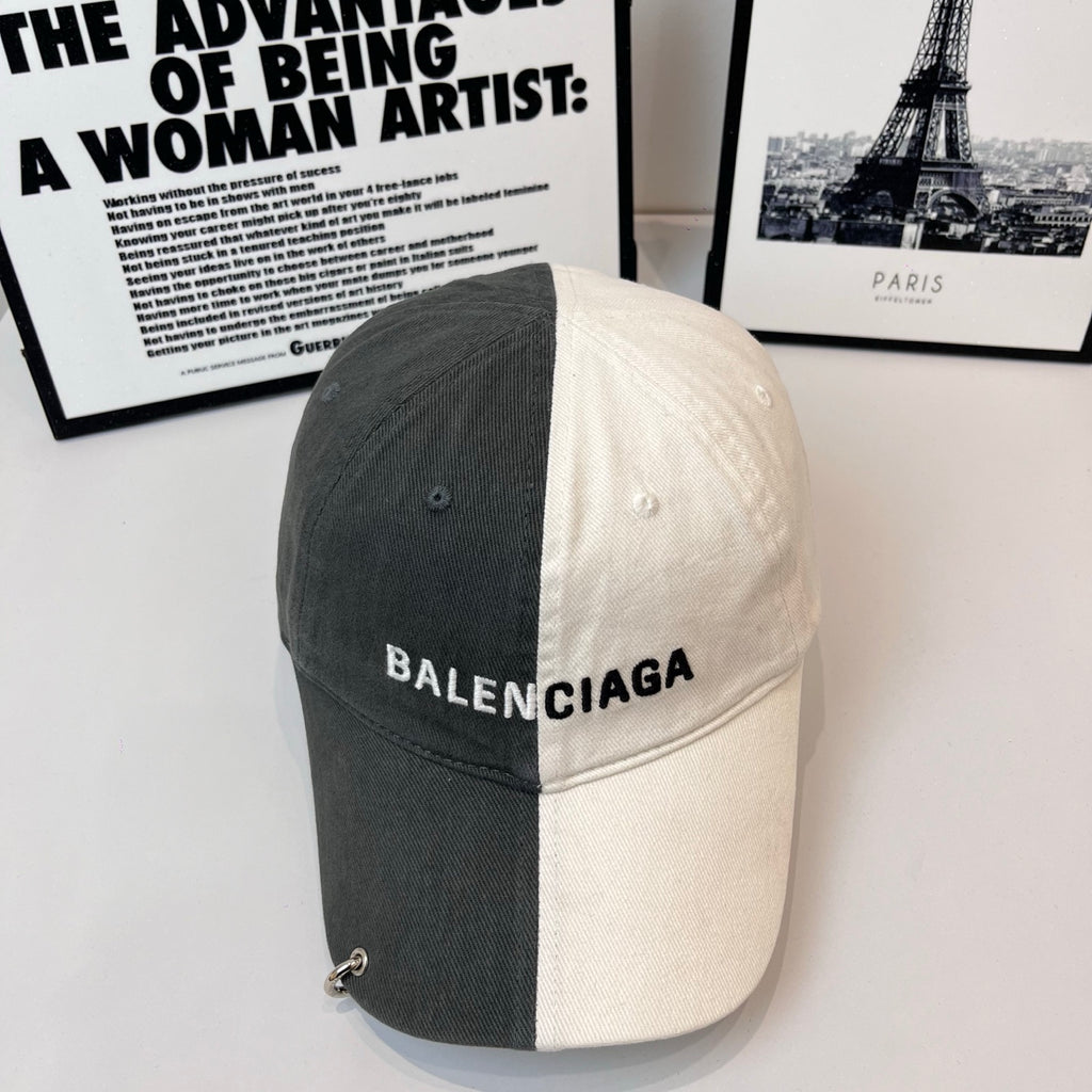 Two-tone baseball cap, dark gray and off-white, BALENCIAGA logo on front.