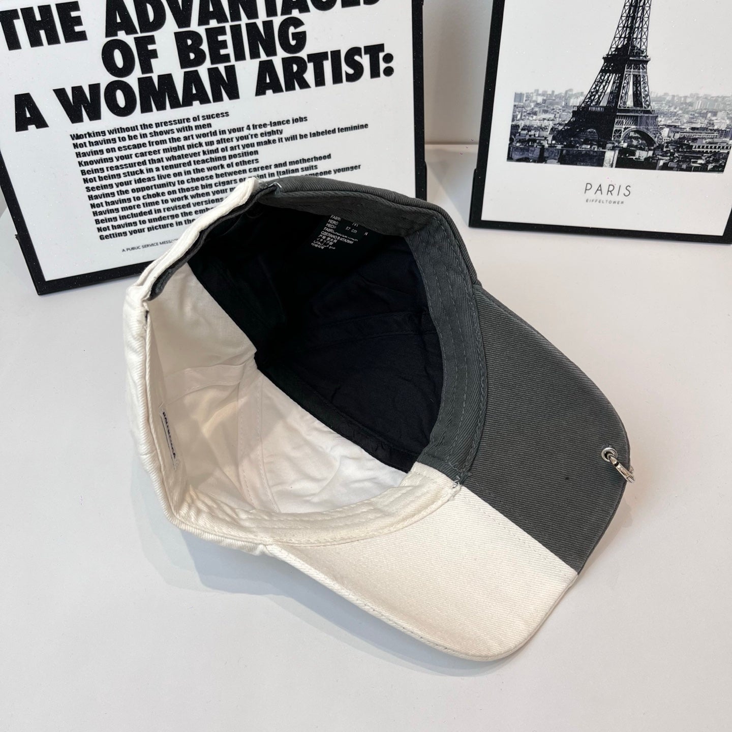 Two-tone cap interior view, black lining with off-white brim edge trim.