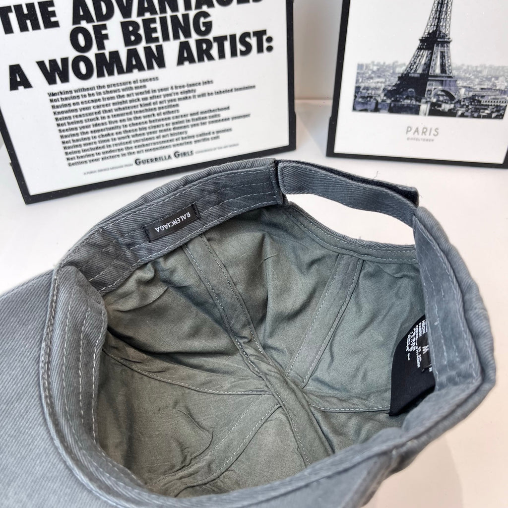 Baseball cap interior, dark gray lining with inner label and stitched seam.