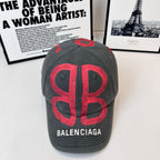 Gray baseball cap with large red Balenciaga letter graphic on front