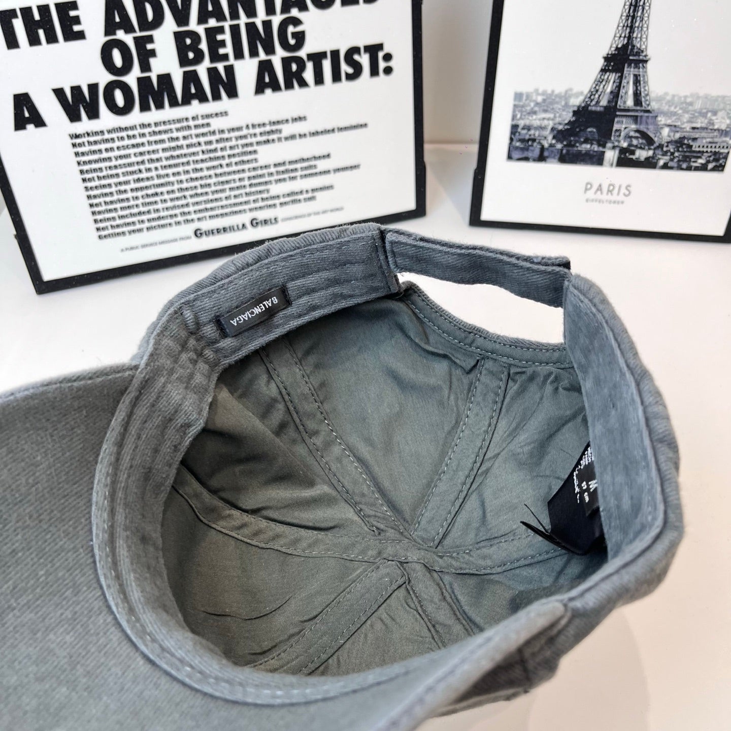 Gray baseball cap interior lining with small fabric tag inside