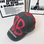 Gray baseball cap with red Balenciaga logo graphic and stitched brim