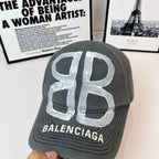 Balenciaga cap, dark gray, front view with silver monogram logo and BALENCIAGA label