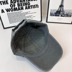 Dark gray baseball cap viewed from side with interior panels and stitching