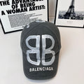 Dark gray baseball cap with large silver 'B' and BALENCIAGA logo front