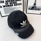 Balenciaga baseball cap, 3/4 angle, dark fabric with white trefoil and logo