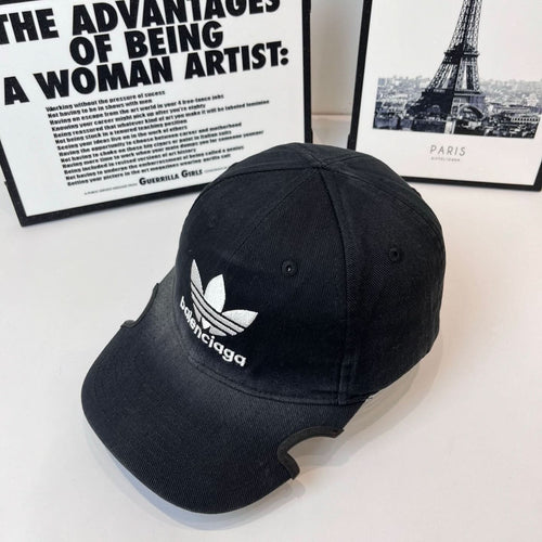 Balenciaga baseball cap, side view, dark with white trefoil logo and branding