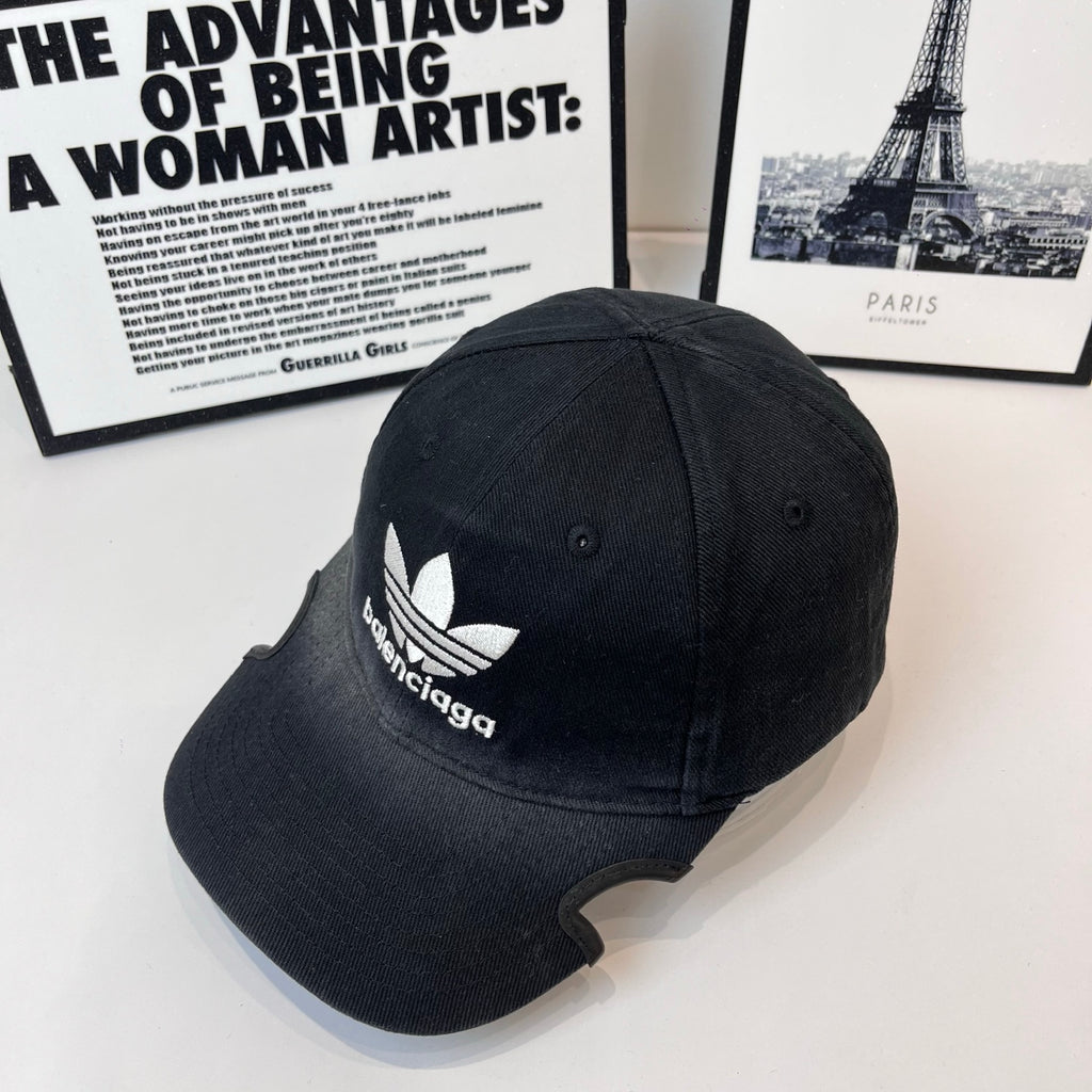 Black baseball cap with white trefoil and Balenciaga logo, side view