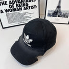 Black baseball cap with white trefoil and Balenciaga logo, side view