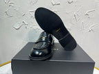 Amiri black leather loafer shoe with gold emblem, shown with outsole and upper