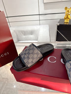 Gucci GG monogram slide sandals with single wide strap and black sole