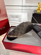 Gucci GG monogram slide sandal with beige patterned strap and black outsole