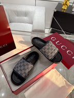 Gucci GG logo sandals with beige patterned straps and black cushioned footbed