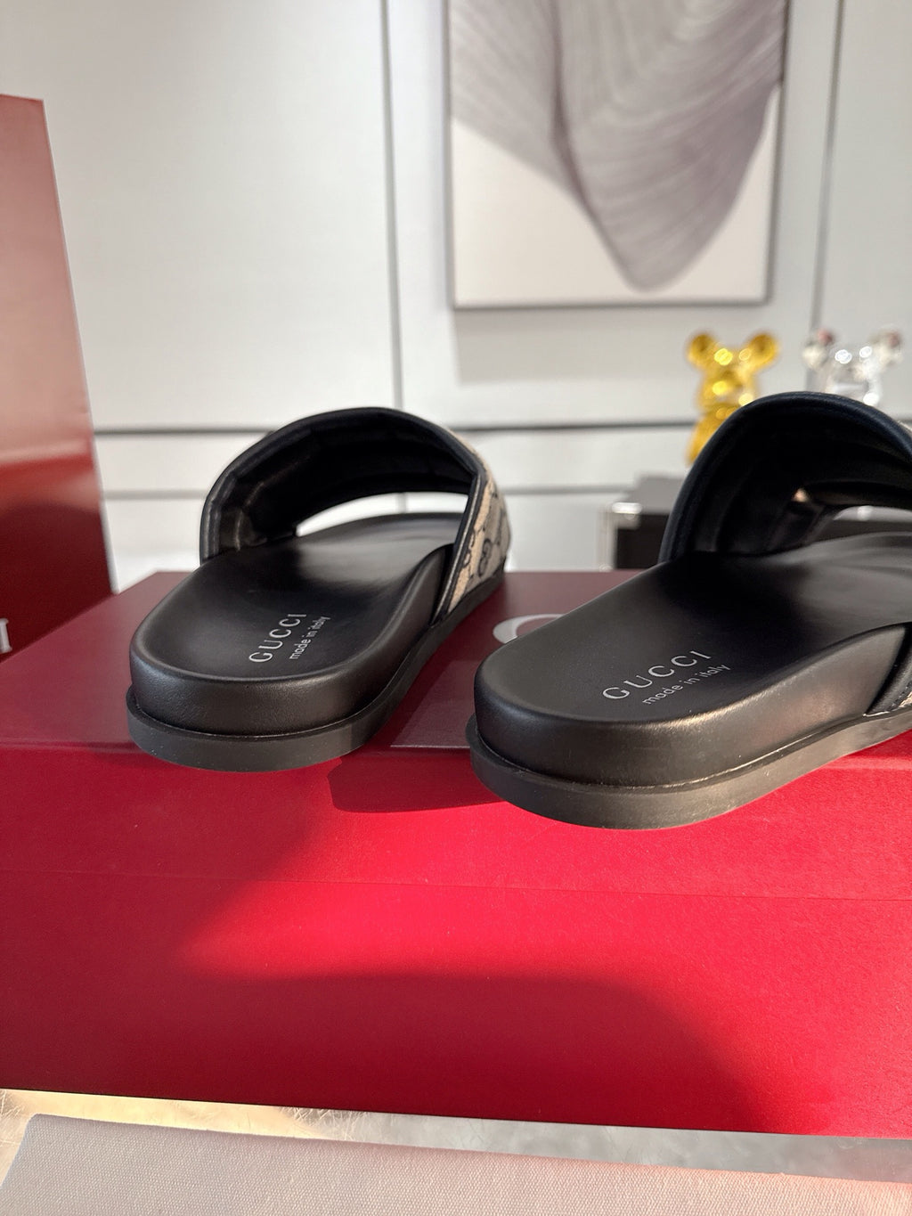 Gucci sandals with black footbeds and straps tucked over the rubber soles