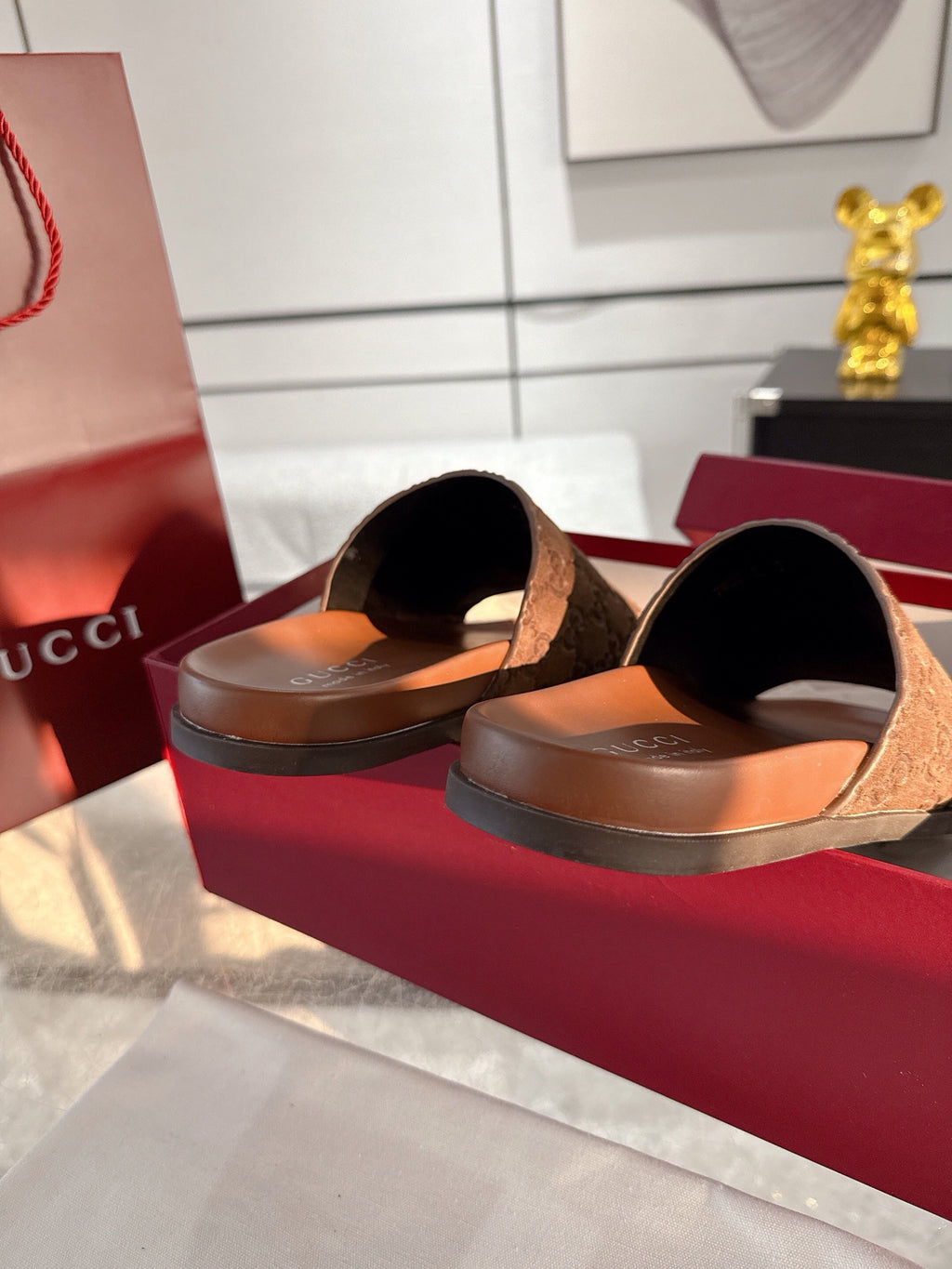 Gucci monogram slide sandals, dark brown, curved footbed opening with wide strap.