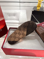 Gucci monogram slide sandal, dark brown, GG-pattern wide strap and open toe.