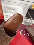 Gucci slide sandal footbed, dark brown with embossed Gucci logo.