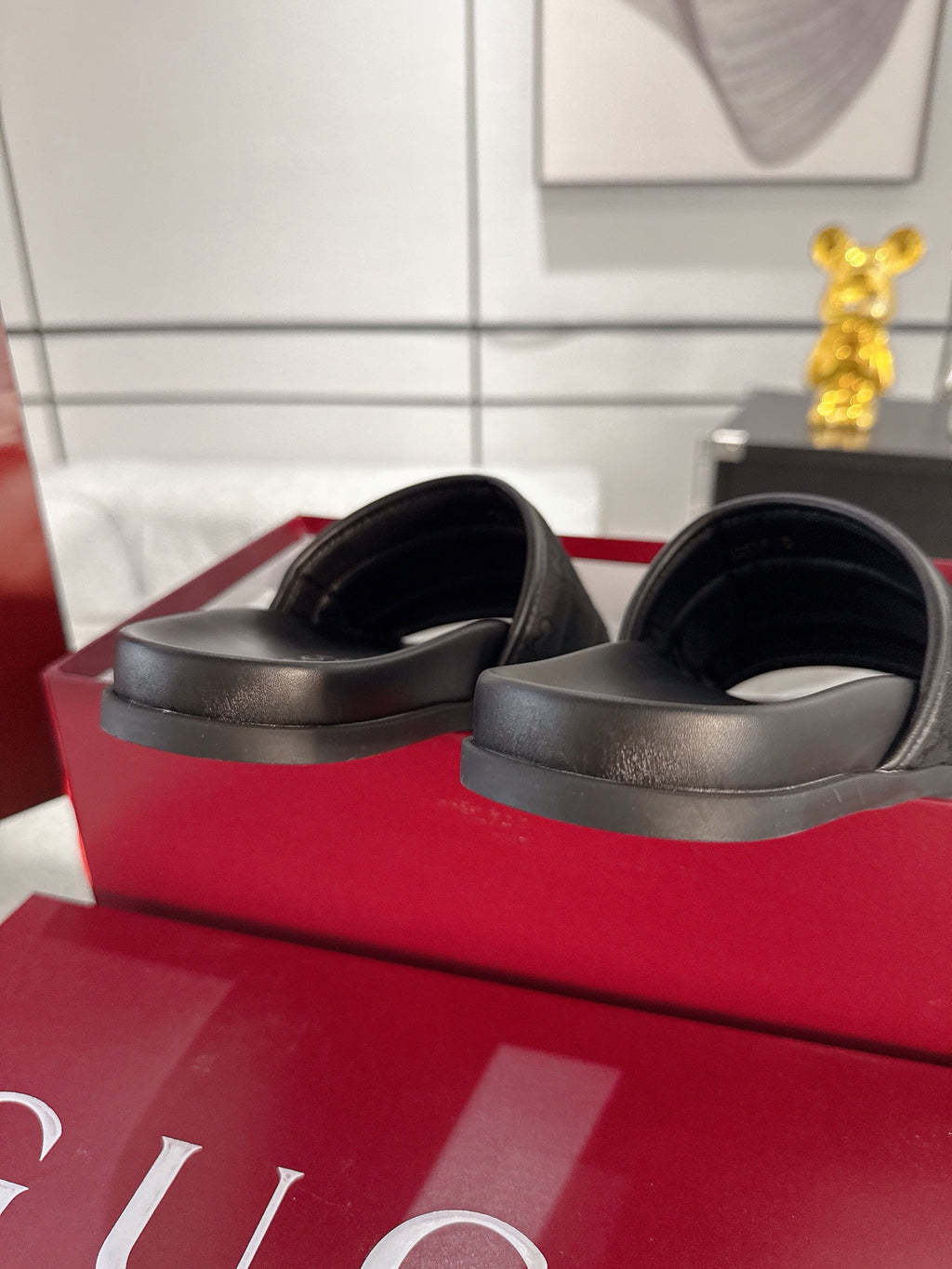 Gucci black slide sandals with smooth matte foot straps and rounded open toe