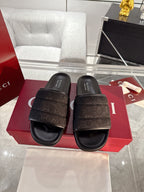 Gucci black slide sandals with wide logo strap, cushioned footbed, buckle strap detail