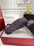Gray slide sandals with wide monogram strap and cushioned footbed, Gucci logo on insole