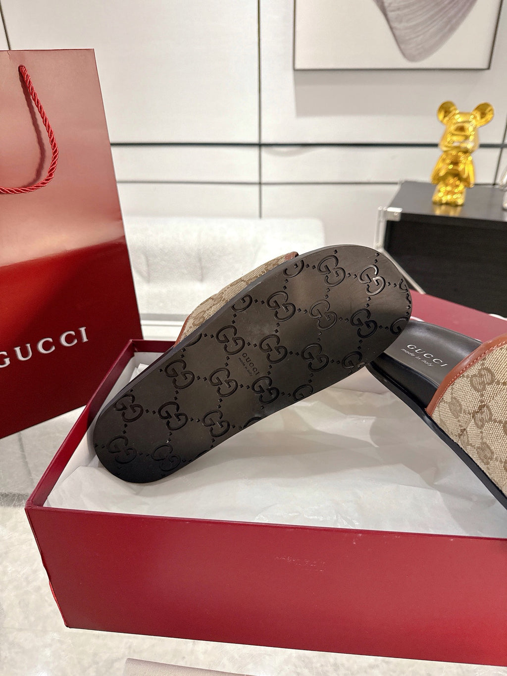 Gucci slide sandal outsole view, dark sole with GG monogram texture