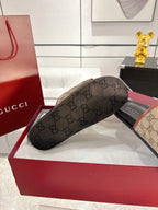 Gucci slide sandal outsole view, dark sole with GG monogram texture