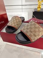 Gucci slide sandals, beige GG canvas uppers with black footbeds and tan trim