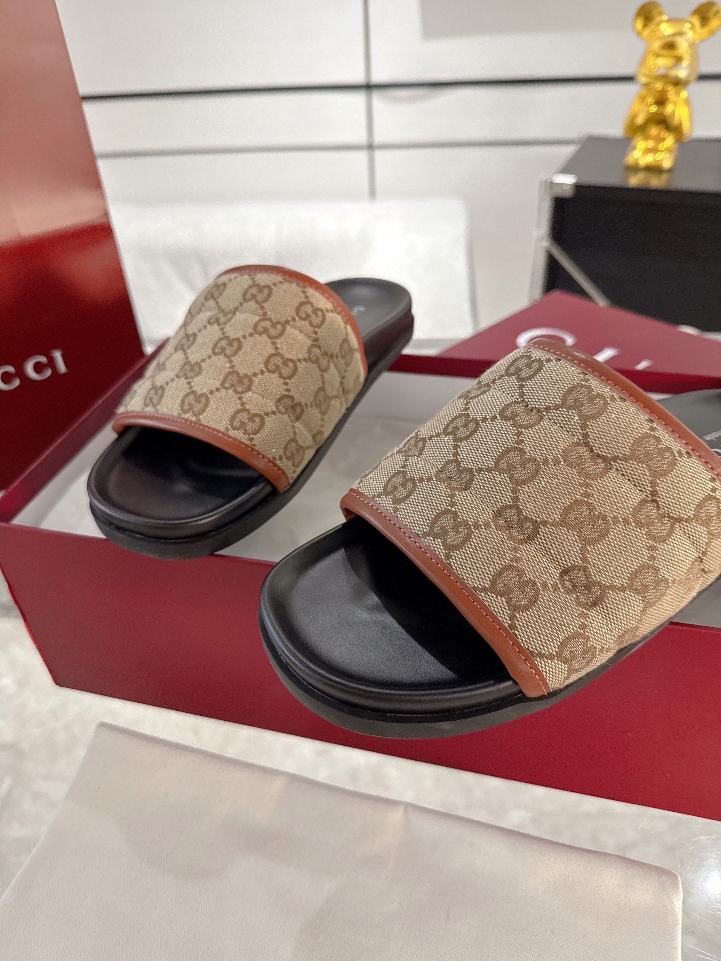Gucci slide sandals, beige GG canvas uppers with black footbeds and tan trim