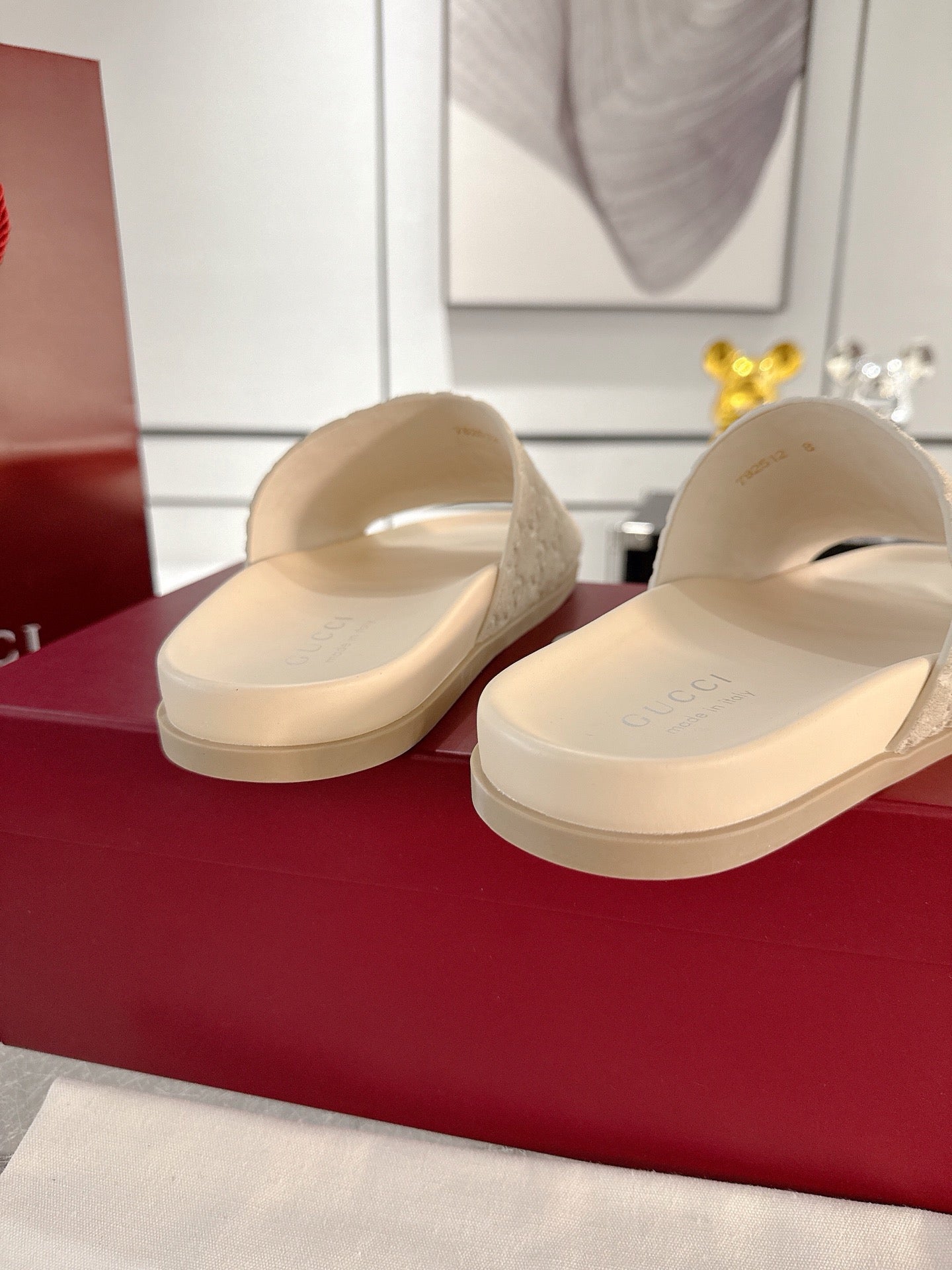 Gucci slide sandals, light beige, side view with flat slide sole