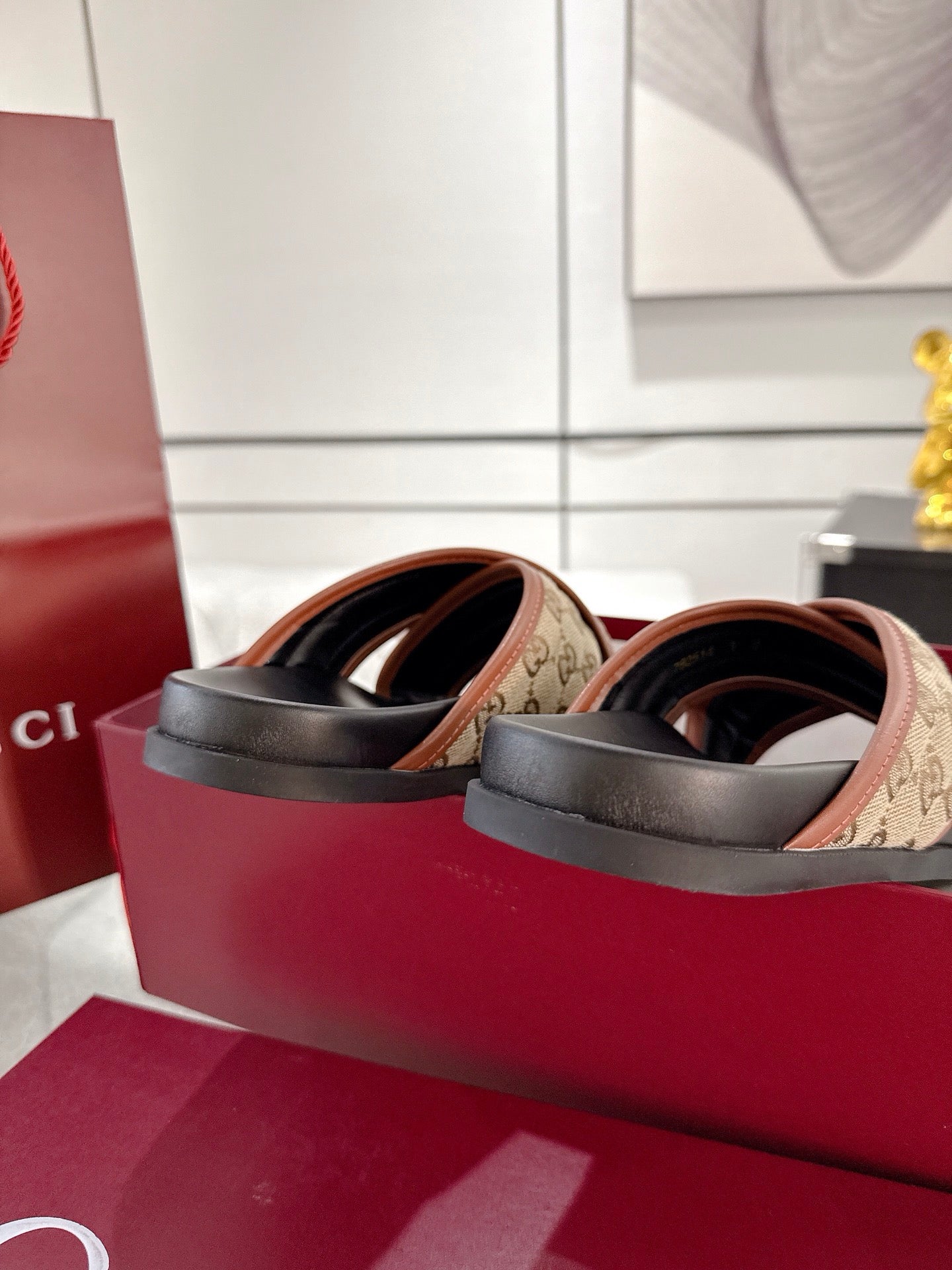 Gucci slide sandals side profile, black sole with beige GG canvas strap