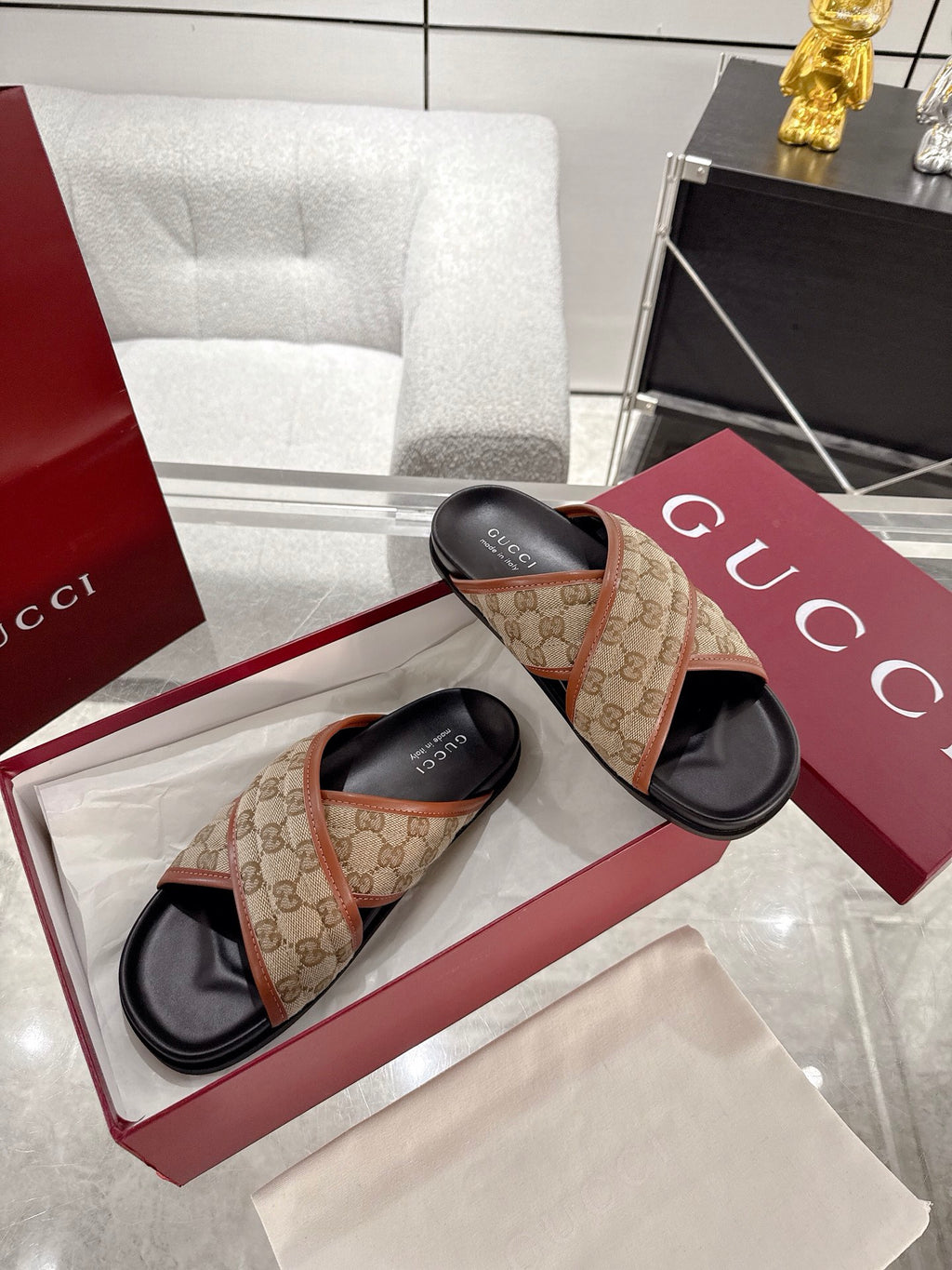 Gucci slide sandals with beige GG canvas straps and tan edging, black slides on box