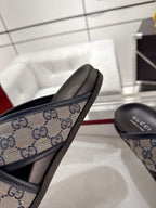 Gucci slide sandal close-up of blue GG canvas strap and black footbed