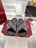 Gucci slide sandals with blue GG canvas straps and black rubber soles