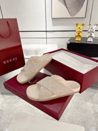 Gucci beige slide sandals with patterned strap detail and molded footbed