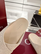 Close-up of Gucci beige slide sandal insoles and molded footbed