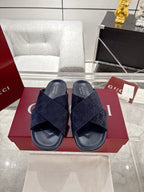 Gucci slide sandals with dark blue GG-pattern straps and navy rubber sole