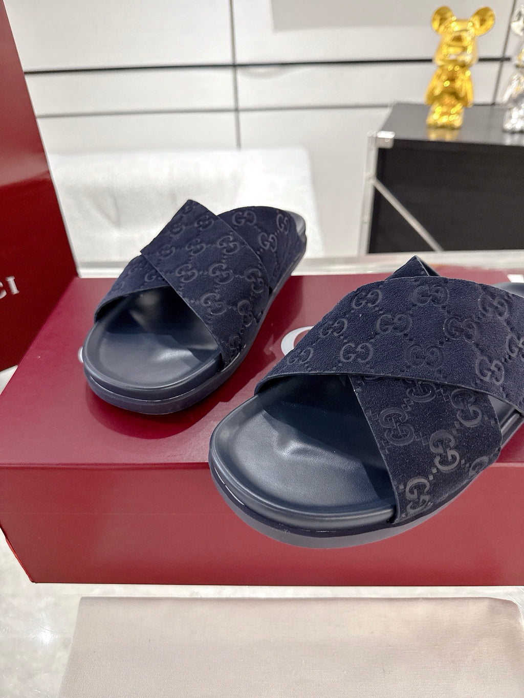 Gucci dark blue slide sandals with GG-pattern crossed strap and contoured rubber footbed