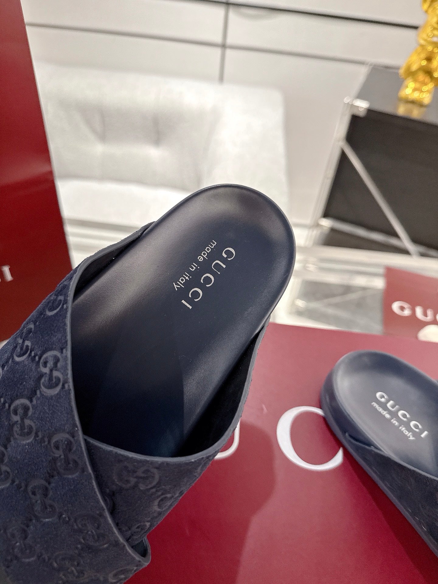 Gucci slide sandals, dark blue foot strap with GG logo and smooth rubber sole