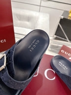 Navy Gucci slide sandals, open toe, showing cushioned footbed and GG pattern