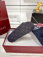 Navy Gucci slide sandal with GG monogram strap and adjustable buckle, detail