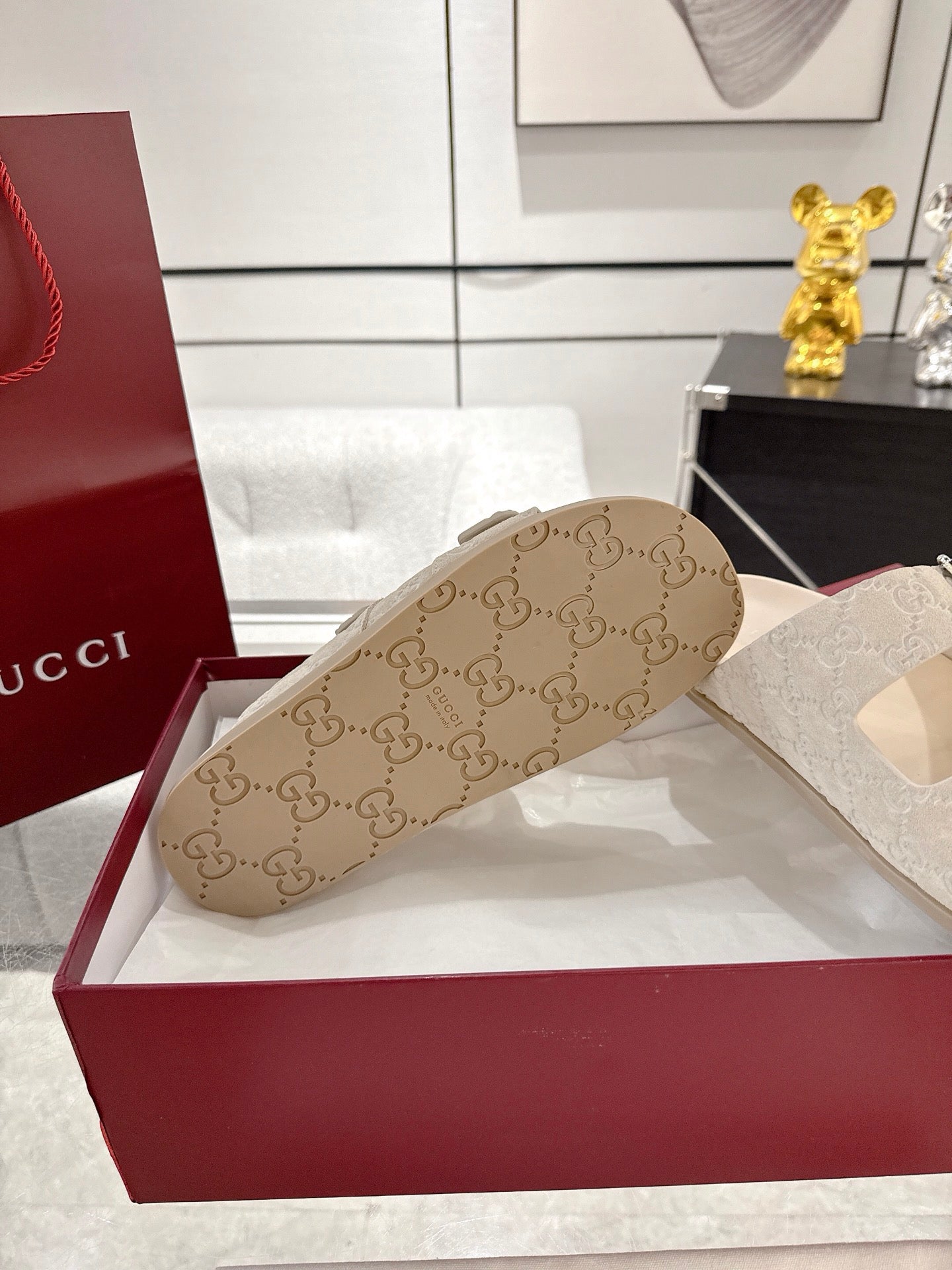 Gucci sandal outsole view with beige patterned footbed and monogram detailing