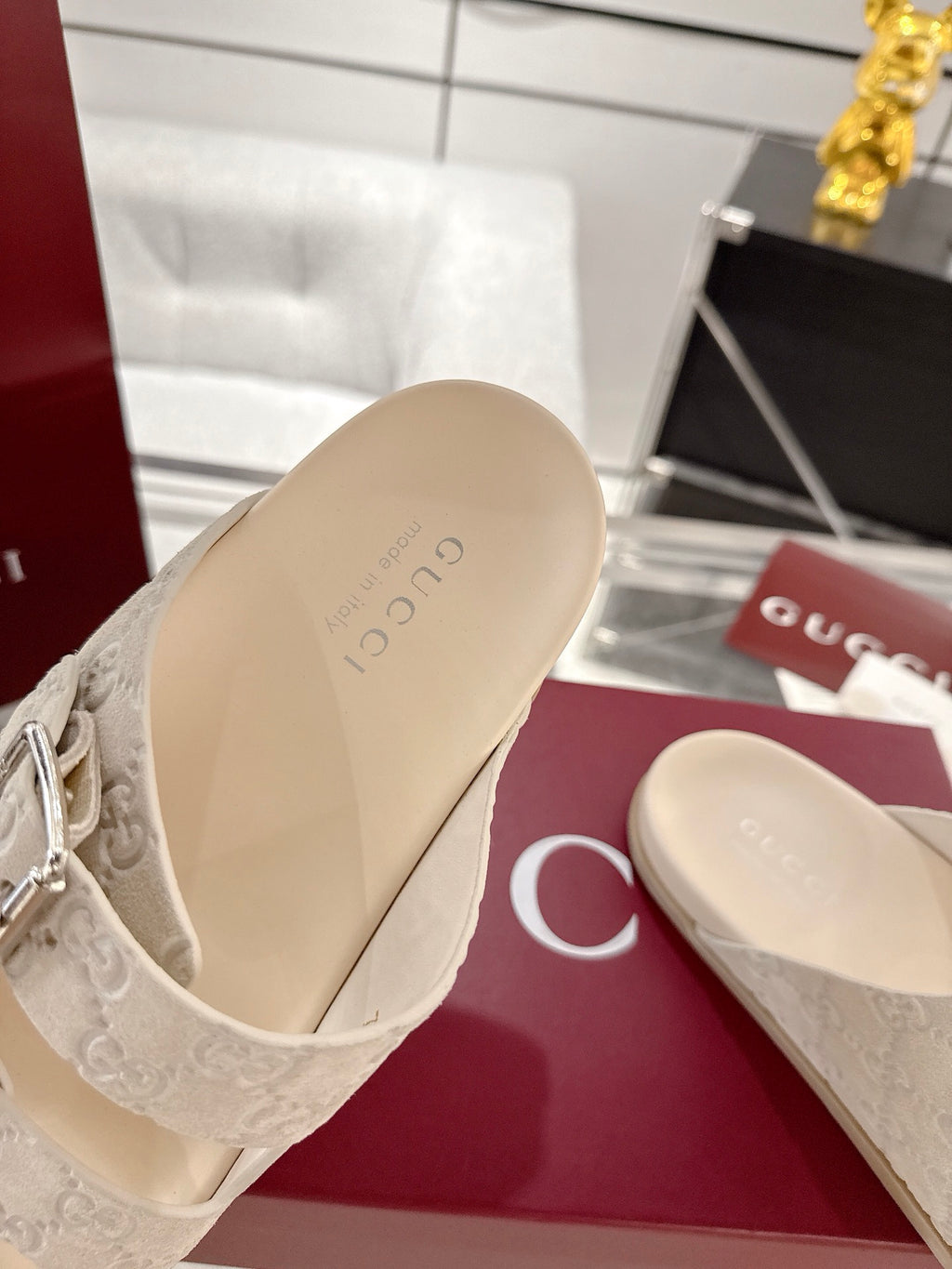 Gucci sandal footbed close-up in beige, showing monogram strap attachment