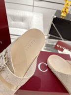 Gucci sandal footbed close-up in beige, showing monogram strap attachment