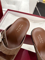 Brown slide sandal footbed with logo text, showing open toe and side strap