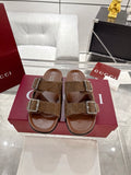 Brown logo-print slide sandals with two silver-tone buckle straps and open toe