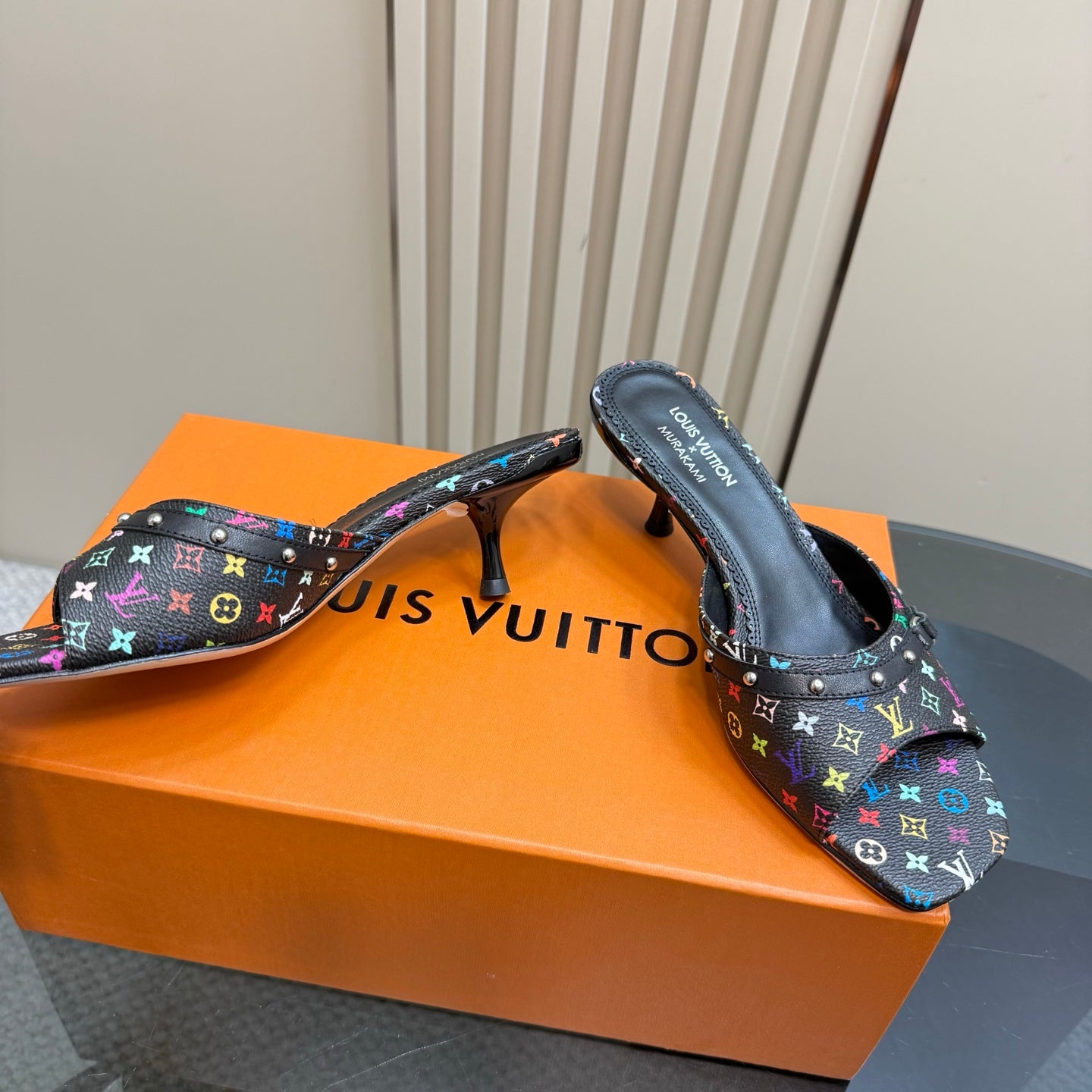 Louis Vuitton women's mule heels with stiletto heel, multicolor logo print close-up