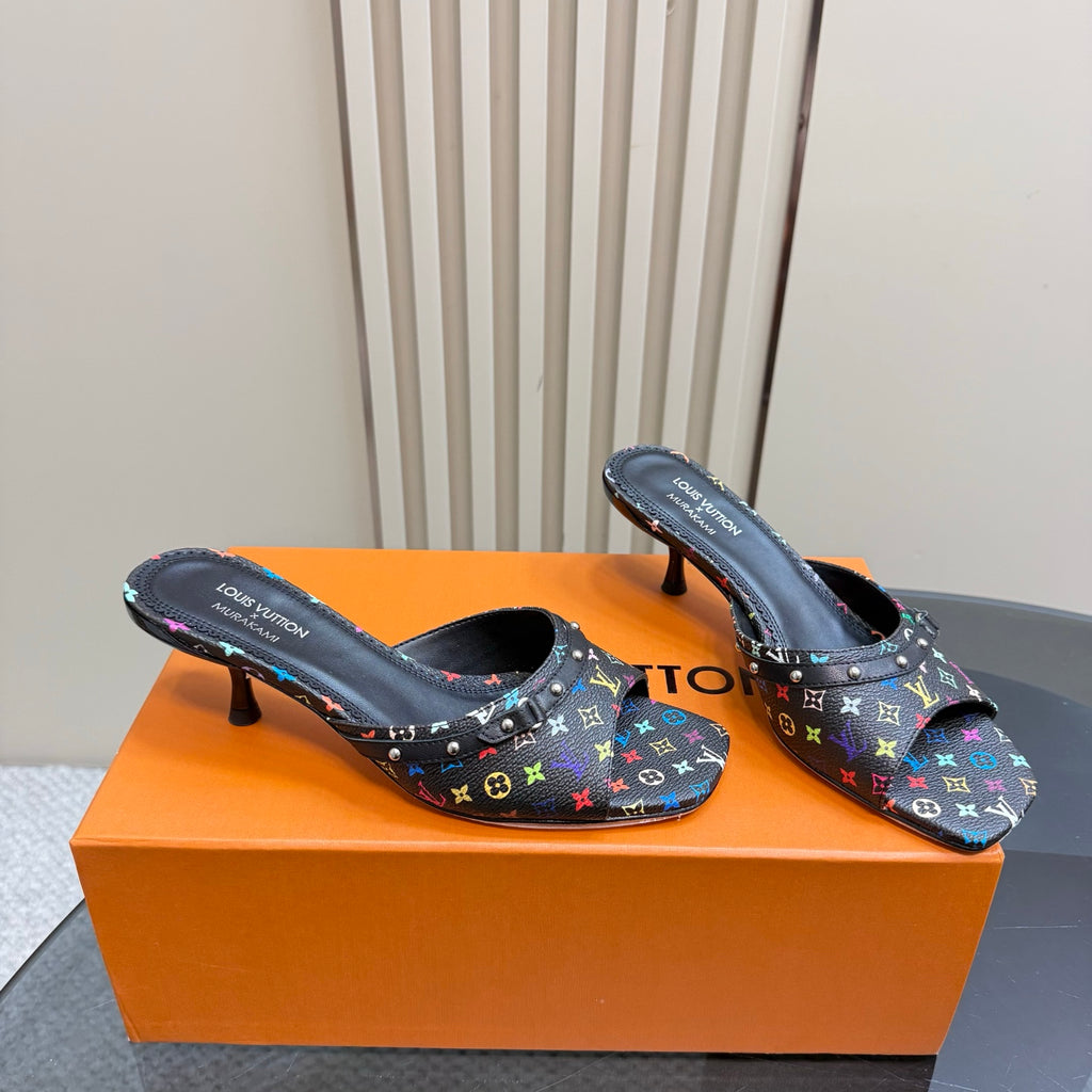 Louis Vuitton women's mule heels, black multicolor logo print, angled view on box