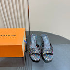 Louis Vuitton women's mule heels in black logo fabric, front view on box