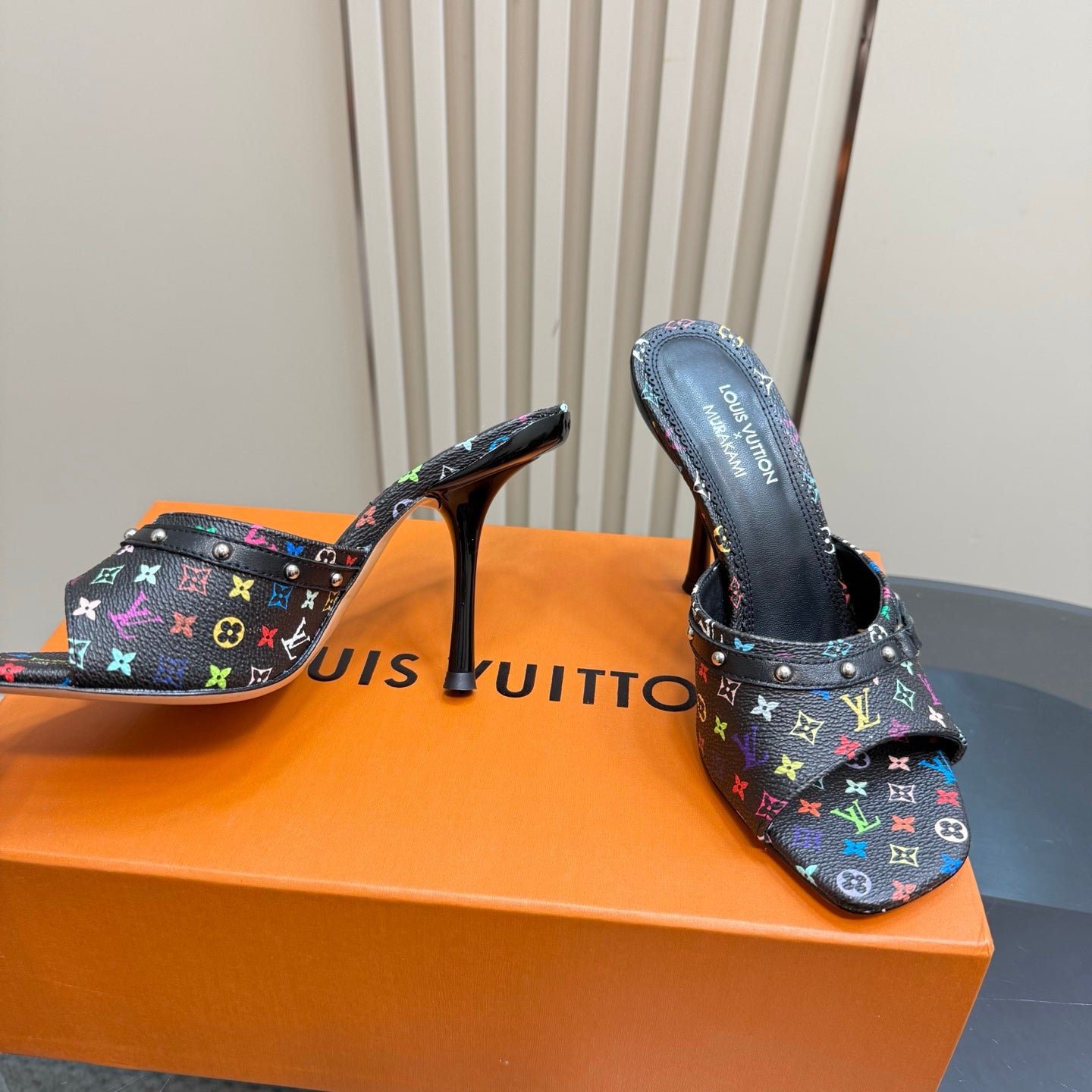 Louis Vuitton heeled mules, side view: black multicolor monogram strap with stud trim