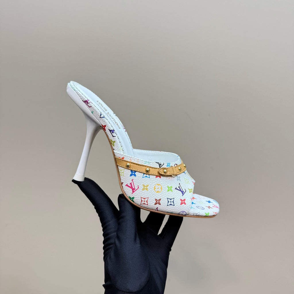 Light blue patterned mule heel with gold strap and white stiletto heel, side view